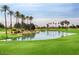 Beautiful lake on the golf course with palm trees providing a relaxing atmosphere at 14314 W Pecos Ln, Sun City West, AZ 85375