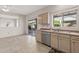 Open concept kitchen with stainless appliances and breakfast nook with sliding glass door to patio at 14314 W Pecos Ln, Sun City West, AZ 85375