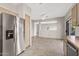 An open kitchen area adjacent to a dining room with a stainless steel refrigerator at 14314 W Pecos Ln, Sun City West, AZ 85375