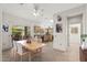 Bright kitchen with tile floor, wooden cabinets, dining area, and sliding glass doors to the backyard at 14314 W Pecos Ln, Sun City West, AZ 85375