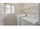 Close up shot of a clean laundry room with modern washer and dryer units at 14314 W Pecos Ln, Sun City West, AZ 85375