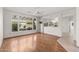 Bright living room with hardwood floors, a ceiling fan, and sliding glass doors to the backyard at 14314 W Pecos Ln, Sun City West, AZ 85375