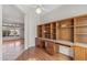 Bright office space featuring built-in shelving and a seamless transition to the living area at 14314 W Pecos Ln, Sun City West, AZ 85375