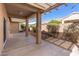 Covered patio with beige pillars offering a shaded view of the yard and landscaping at 14314 W Pecos Ln, Sun City West, AZ 85375