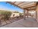 Covered patio with shade structure and desert landscaping, offering an outdoor living space at 14314 W Pecos Ln, Sun City West, AZ 85375