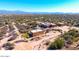 Aerial view of an estate featuring multiple buildings on a large desert lot with mountain views at 14925 E Morning Vista Ln, Scottsdale, AZ 85262