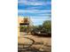 Desert backyard featuring a spiral staircase and a stone walkway to the patio at 14925 E Morning Vista Ln, Scottsdale, AZ 85262