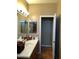 Bathroom with sink and vanity featuring dual mirrors and wood cabinets at 14925 E Morning Vista Ln, Scottsdale, AZ 85262