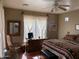 Bright bedroom features decorative mirror, fan, and an eye-catching southwestern-style comforter at 14925 E Morning Vista Ln, Scottsdale, AZ 85262