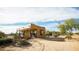 Tan house with desert landscaping, stone walkway, and a covered porch at 14925 E Morning Vista Ln, Scottsdale, AZ 85262