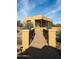 Tan home featuring a brick walkway, beautiful desert landscaping, and a covered porch at 14925 E Morning Vista Ln, Scottsdale, AZ 85262