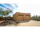 A tan-colored home with two garage doors with landscaping in a desert environment at 14925 E Morning Vista Ln, Scottsdale, AZ 85262