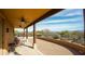 Spacious covered patio with ceiling fans, brick flooring, and a desert landscape view at 14925 E Morning Vista Ln, Scottsdale, AZ 85262