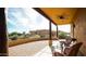 Covered patio with ceiling fan, brick flooring, and desert landscaping at 14925 E Morning Vista Ln, Scottsdale, AZ 85262