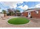 Spacious backyard featuring artificial turf, a hammock, and covered patio for entertaining and relaxation at 1512 W Fairmont Dr, Tempe, AZ 85282