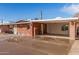 Side view of a single-story brick home with a covered carport and spacious driveway in a residential neighborhood at 1512 W Fairmont Dr, Tempe, AZ 85282