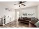 Well-lit living room with wood-look floors, neutral-toned furniture, a side cabinet, and a comfortable seating arrangement at 1512 W Fairmont Dr, Tempe, AZ 85282