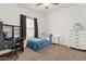 Bedroom with carpet flooring, a closet, a desk, and a comfortable space to relax and play at 15203 N 28Th Pl, Phoenix, AZ 85032