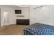 Bedroom with carpet flooring, a closet, a TV and a dresser with a simple modern design at 15203 N 28Th Pl, Phoenix, AZ 85032