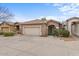 Charming single-story home featuring a two-car garage, landscaped front yard, and a welcoming front entrance at 15203 N 28Th Pl, Phoenix, AZ 85032
