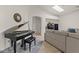 Living area featuring a grand piano, plush seating, and bright, natural light at 15203 N 28Th Pl, Phoenix, AZ 85032