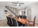 Dining area with a large wooden table, decorative chairs, and a staircase in the background at 15658 W Cortez St, Surprise, AZ 85379