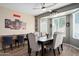 Dining room with a dark wood table, upholstered chairs, and a bay window at 15658 W Cortez St, Surprise, AZ 85379