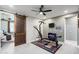 Exercise room with a ceiling fan, mirrored closet doors, a home gym and access to another room via a barn door at 15658 W Cortez St, Surprise, AZ 85379