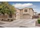 Two-story home featuring a three-car garage and neutral-colored exterior paint at 15658 W Cortez St, Surprise, AZ 85379