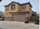 Two-story home featuring an attached two-car garage and a private gated entrance at 16648 W Jenan Dr, Surprise, AZ 85388