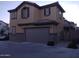 Two story home boasts an attached two car garage and neutral color scheme at 16648 W Jenan Dr, Surprise, AZ 85388