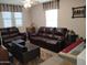 Cozy living room with matching leather furniture and lots of natural light at 16648 W Jenan Dr, Surprise, AZ 85388