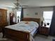 The main bedroom offers a tranquil space with neutral tones, a ceiling fan, and large windows at 16648 W Jenan Dr, Surprise, AZ 85388