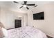 Well-lit bedroom showcases a ceiling fan, TV, and a large dresser at 1735 W Wildwood Dr, Phoenix, AZ 85045