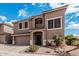 Attractive tan two story home with well-manicured desert landscaping and a spacious two car garage at 1735 W Wildwood Dr, Phoenix, AZ 85045