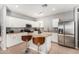 Well-equipped kitchen featuring white cabinets, stainless steel appliances, and an island with bar stools at 1735 W Wildwood Dr, Phoenix, AZ 85045