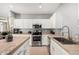 Well-lit kitchen featuring stainless steel appliances, granite countertops, and white cabinetry at 1735 W Wildwood Dr, Phoenix, AZ 85045