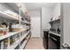 Well-organized laundry room features shelving, and sleek, modern appliances at 1735 W Wildwood Dr, Phoenix, AZ 85045