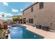 Backyard pool features a water fountain, lounge chairs, and outdoor seating for entertaining on a sunny day at 1735 W Wildwood Dr, Phoenix, AZ 85045