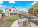 The spacious backyard features a putting green, pool, and covered patio at 17771 W Caribbean Ln, Surprise, AZ 85388