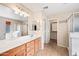 Well-lit bathroom with double sinks, ample counter space, and a walk-in closet at 17771 W Caribbean Ln, Surprise, AZ 85388