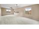 Spacious bedroom with carpet, ceiling fan, and natural light from two windows at 17771 W Caribbean Ln, Surprise, AZ 85388