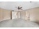 Large carpeted bedroom showcasing multiple doors leading to other rooms in the house at 17771 W Caribbean Ln, Surprise, AZ 85388