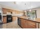 Kitchen with island sink, cabinetry, and updated appliances providing functionality and a contemporary aesthetic at 17771 W Caribbean Ln, Surprise, AZ 85388