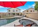 Spacious backyard with a refreshing pool, lounge chairs, and a shaded patio, perfect for enjoying the outdoors at 17771 W Caribbean Ln, Surprise, AZ 85388