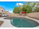 Inviting backyard with a pool, spa, and lounge seating, offering a serene and private outdoor retreat at 17771 W Caribbean Ln, Surprise, AZ 85388