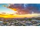 Beautiful sunset view of the neighborhood, mountains, and desert landscape from above at 18097 W Santa Alberta Ln, Goodyear, AZ 85338