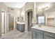 Bathroom with dual sink vanity, modern fixtures, and walk-in closet access at 18097 W Santa Alberta Ln, Goodyear, AZ 85338