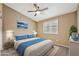 Comfortable bedroom featuring a ceiling fan, neutral walls, and a window for natural light at 18097 W Santa Alberta Ln, Goodyear, AZ 85338