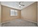 Empty bedroom with gray carpet and a window offering natural light and ventilation at 18097 W Santa Alberta Ln, Goodyear, AZ 85338